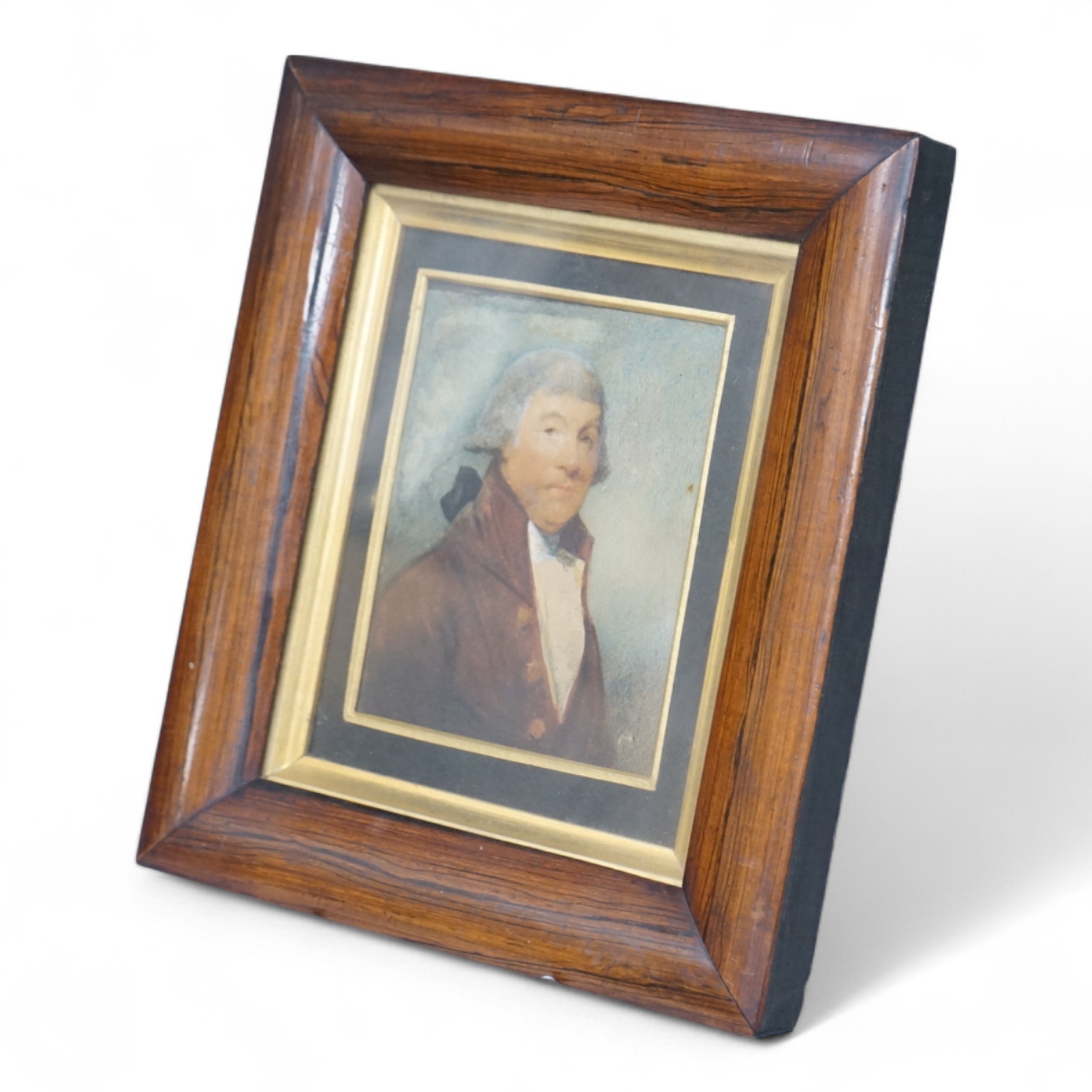 Georgian School, Portrait miniature of a gentleman wearing a frock coat and wig, watercolour on card, framed, 11 x 8cm